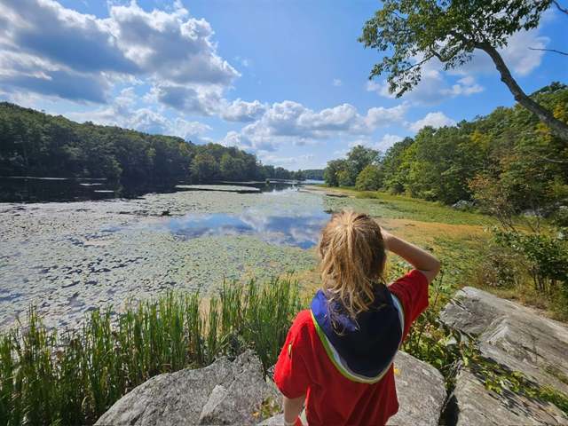 A child looking out over a lake