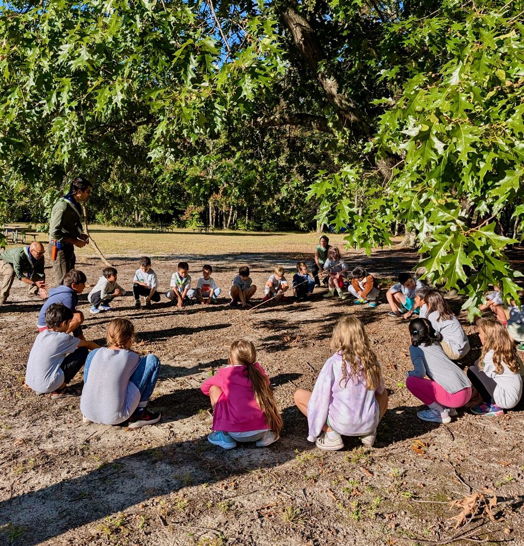 The group gathered in a circle outdoors