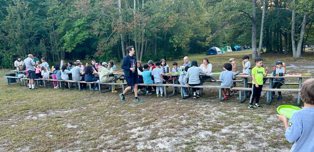 Families sharing a meal at camp