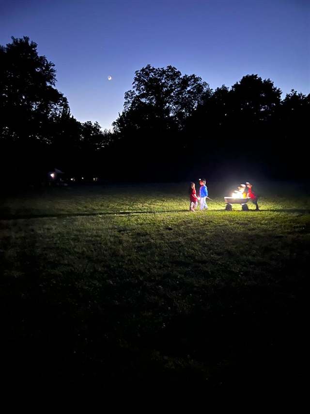 Kids with a campfire wagon at dusk