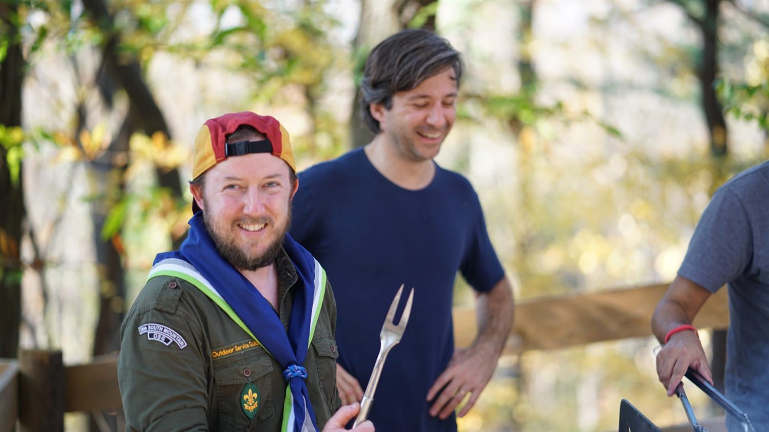 Leaders at a camp cookout, one in Outdoor Service Guides uniform