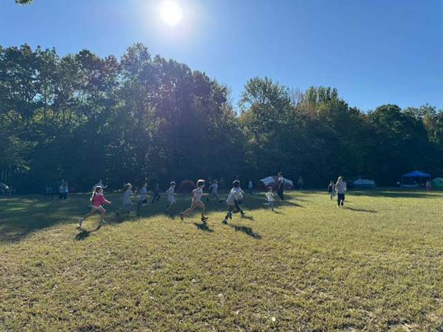 Kids playing on a sunny field at camp